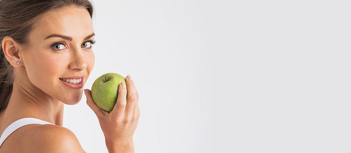 Frau mit Apfel vor der Akupunktur